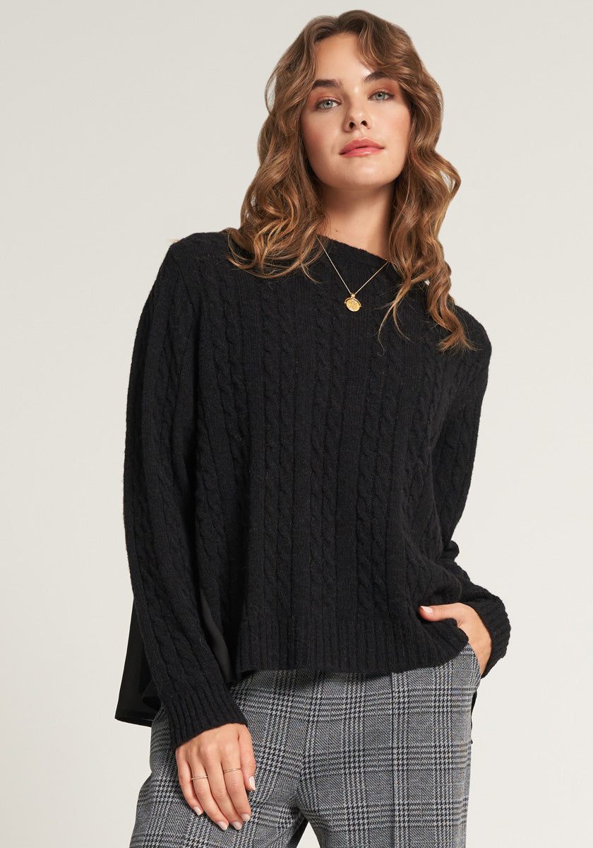 Knitted sweater with flowing insert on the back