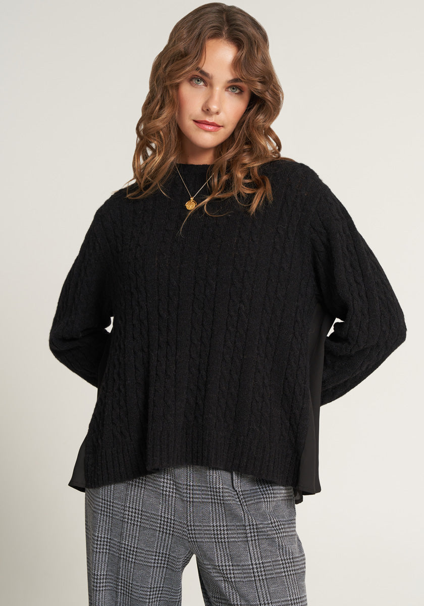 Knitted sweater with flowing insert on the back