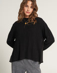 Knitted sweater with flowing insert on the back