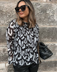 Pleated blouse with feather print