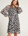 Pleated dress with bow and feather print