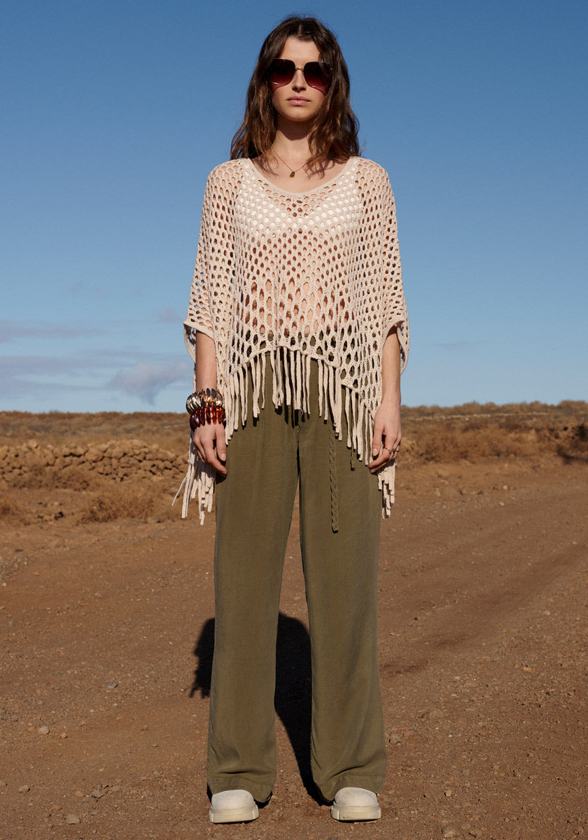 Poncho with net pattern and fringes