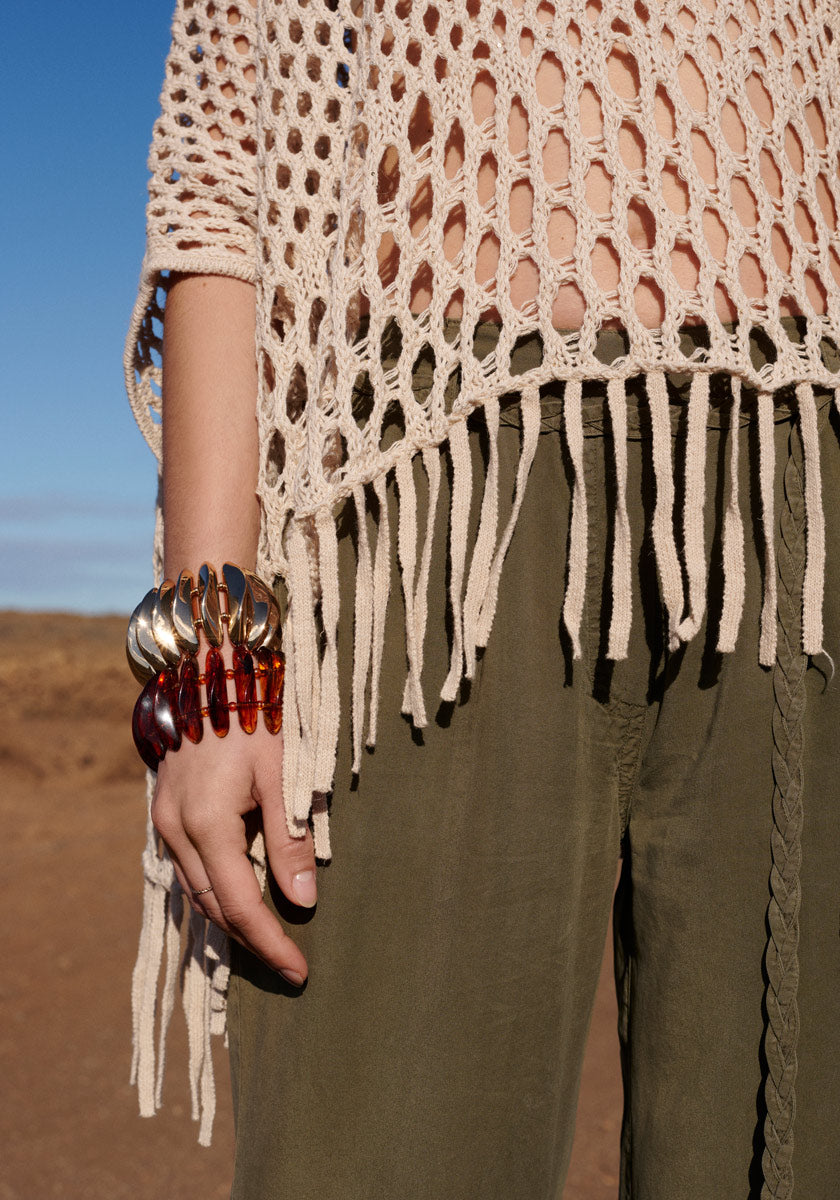 Poncho with net pattern and fringes