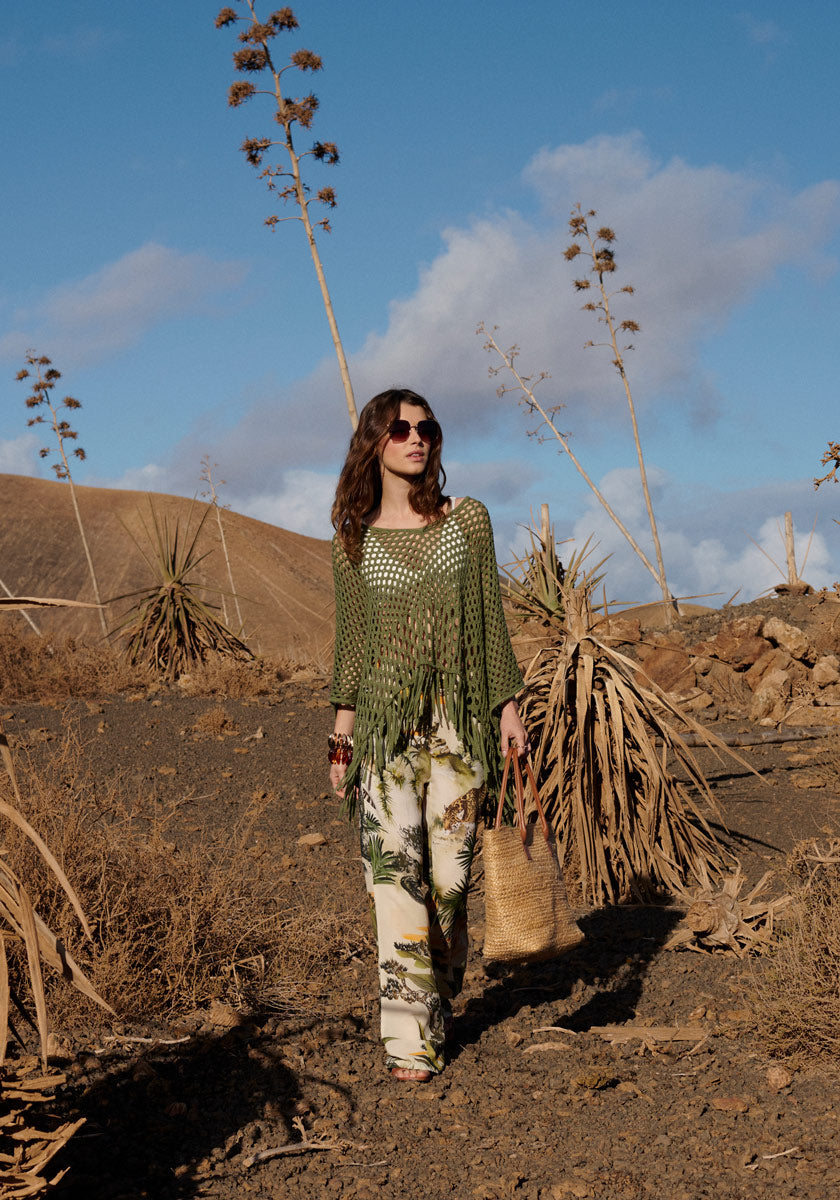 Poncho with net pattern and fringes