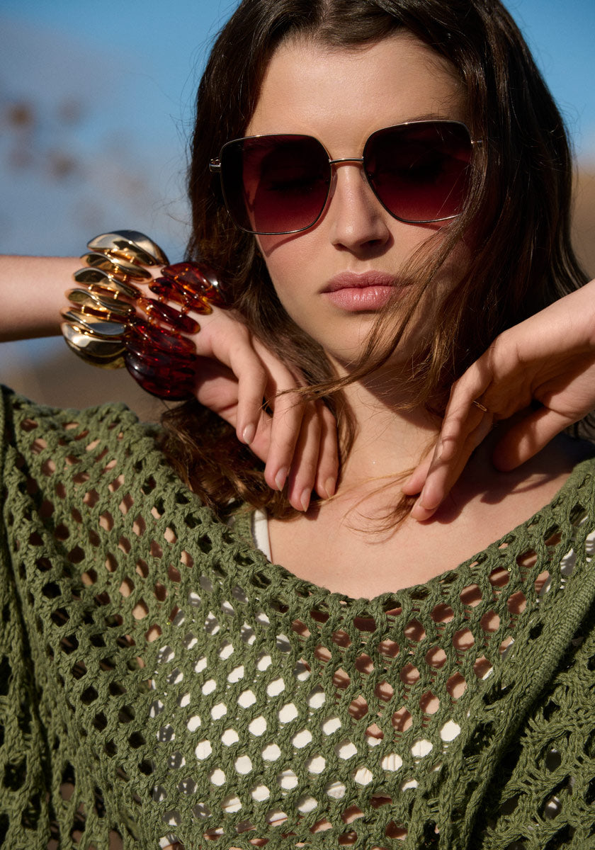 Poncho with net pattern and fringes