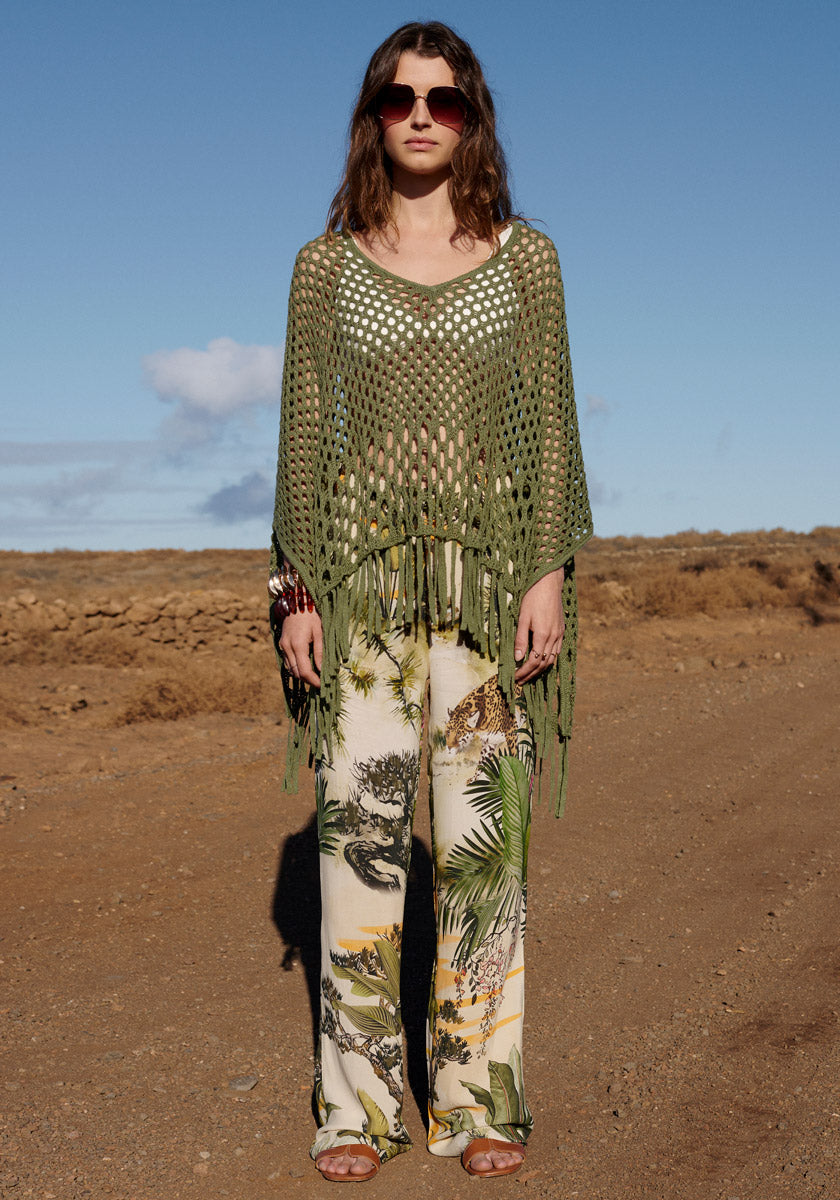 Poncho with net pattern and fringes