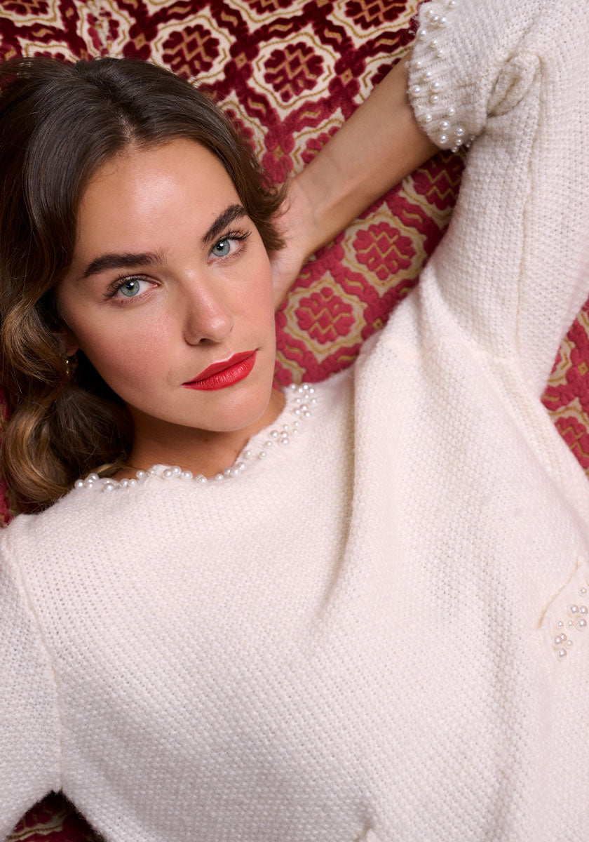 Knitted sweater with pearl decoration